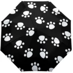 Parapluie chien manuel noir avec empreintes blanches, élégant et pratique pour se protéger de la pluie avec style.