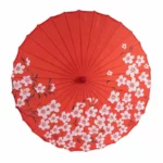 Parapluie chinois rouge en papier huilé, décoré de motifs floraux, accessoire élégant et authentique pour femme et décoration unique.