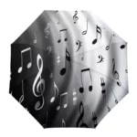 Parapluie manuel noir et blanc avec motif notes de musique, accessoire élégant et pratique pour les jours de pluie.