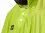Poncho pluie homme vert fluo, imperméable et léger, avec boutons blancs et col monté, idéal pour rester au sec par temps pluvieux.