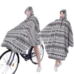 Poncho vélo femme avec visière amovible, motif noir et blanc, idéal pour une protection élégante contre la pluie lors de vos trajets.
