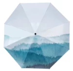 Parapluie imperméable design artistique montagnes, tons bleu et vert, stylé et pratique pour affronter la pluie élégamment.