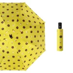 joli parapluie automatique jaune au motif de tête d'ourson sur sa toile.