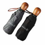 Parapluies pliants gris et noir avec poignée bois élégante. Format compact, design premium, idéal pour le quotidien sous la pluie.