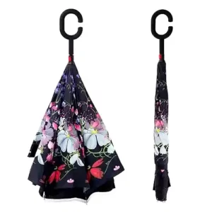 Parapluie inversé à poignée en C noire. Intérieur fleuri avec papillons décoratifs. Séchage propre, maniable, idéal pour déplacements urbains.